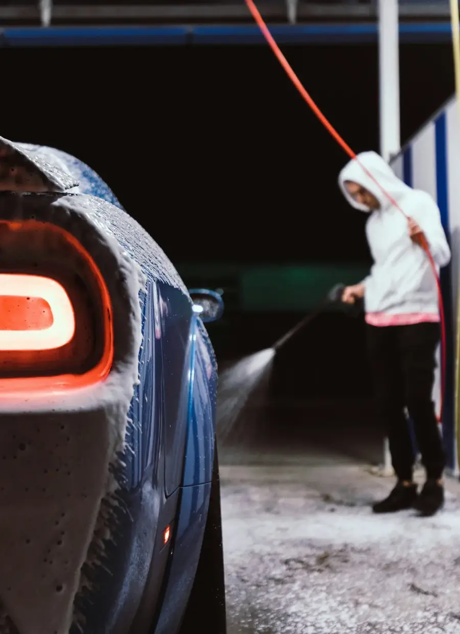 Klant spoelt zijn wagen af in een selfcarwash